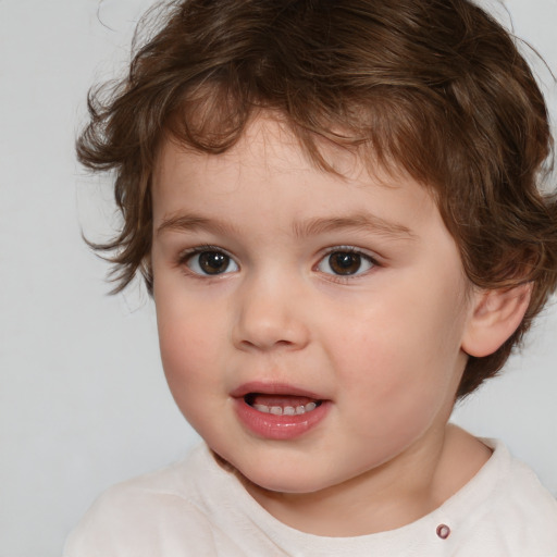 Joyful white child male with medium  brown hair and brown eyes