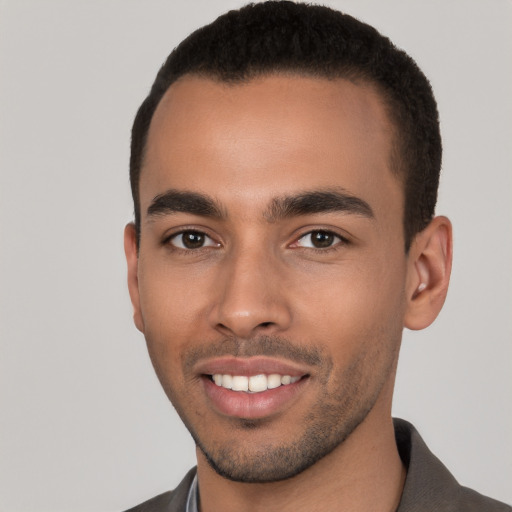 Joyful latino young-adult male with short  brown hair and brown eyes