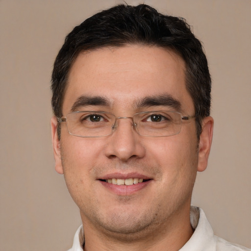 Joyful white adult male with short  brown hair and brown eyes