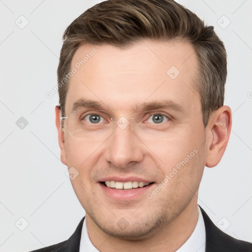 Joyful white young-adult male with short  brown hair and grey eyes