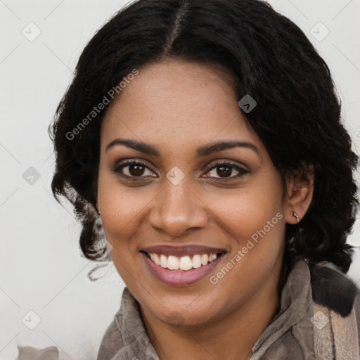 Joyful black young-adult female with long  brown hair and brown eyes