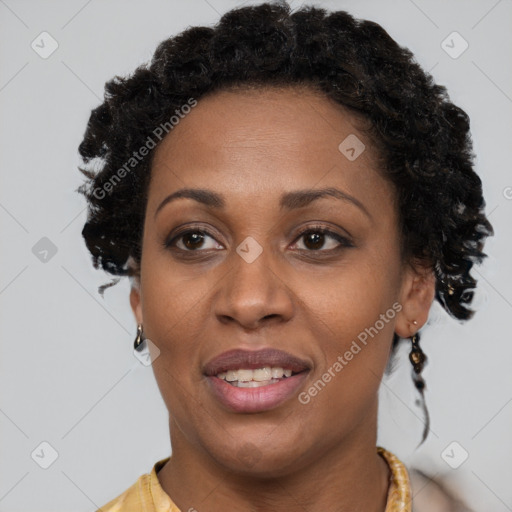 Joyful black adult female with short  brown hair and brown eyes