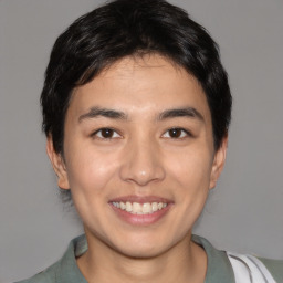 Joyful asian young-adult male with short  black hair and brown eyes