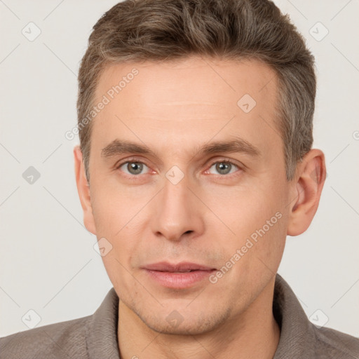 Joyful white adult male with short  brown hair and grey eyes