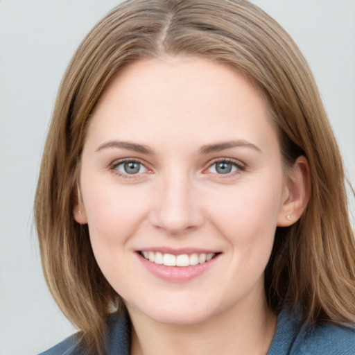 Joyful white young-adult female with medium  brown hair and blue eyes