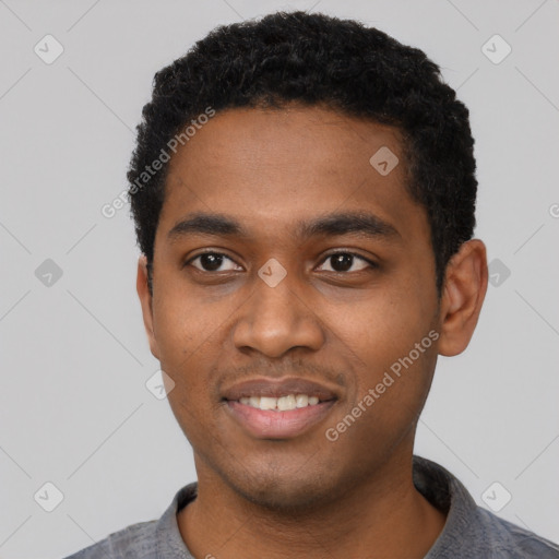 Joyful black young-adult male with short  black hair and brown eyes