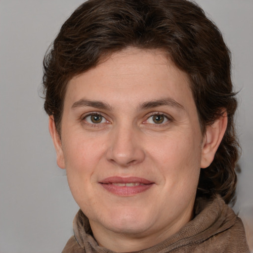 Joyful white adult female with medium  brown hair and grey eyes