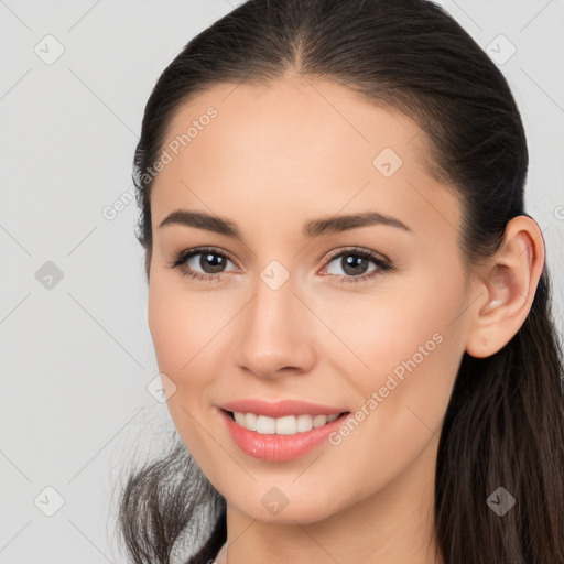 Joyful white young-adult female with long  brown hair and brown eyes