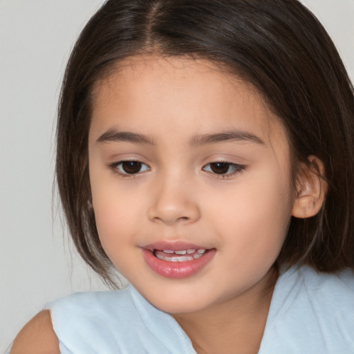 Joyful white child female with medium  brown hair and brown eyes