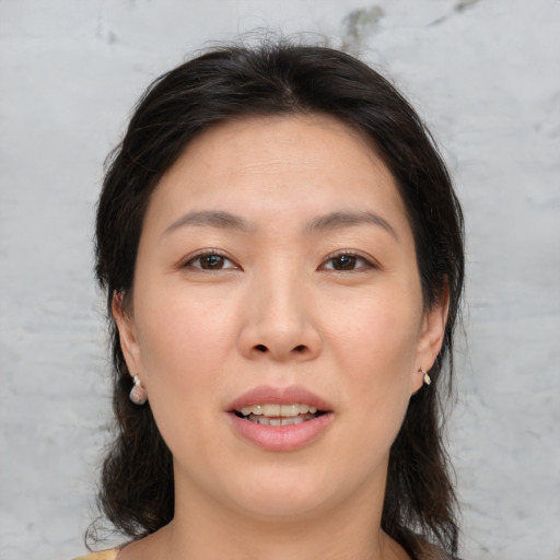 Joyful asian young-adult female with medium  brown hair and brown eyes