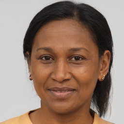 Joyful black adult female with medium  brown hair and brown eyes