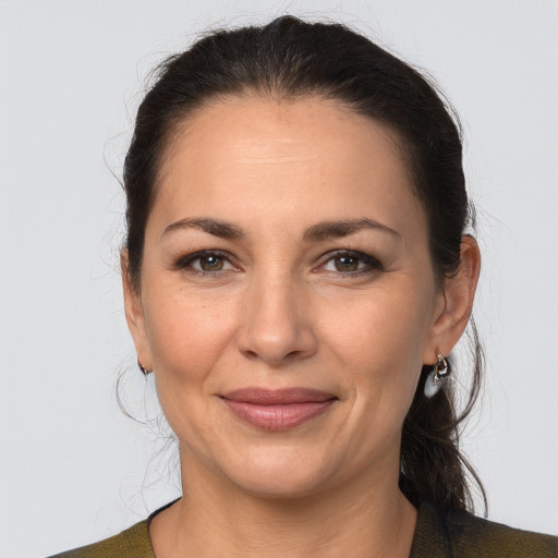 Joyful white adult female with medium  brown hair and brown eyes