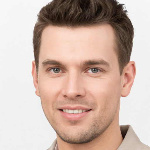 Joyful white young-adult male with short  brown hair and grey eyes