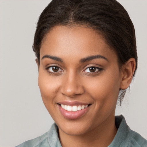 Joyful latino young-adult female with long  brown hair and brown eyes