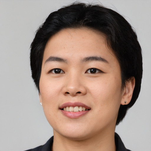 Joyful asian young-adult female with short  black hair and brown eyes