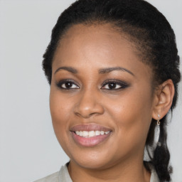 Joyful black young-adult female with long  brown hair and brown eyes