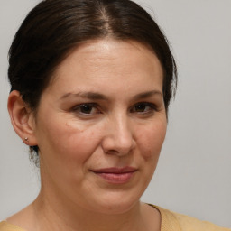 Joyful white adult female with medium  brown hair and brown eyes