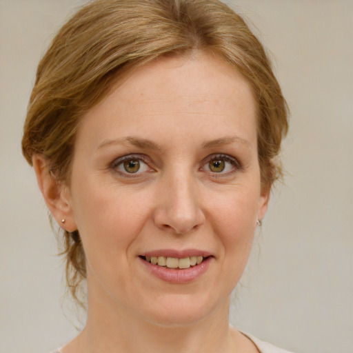 Joyful white adult female with medium  brown hair and blue eyes