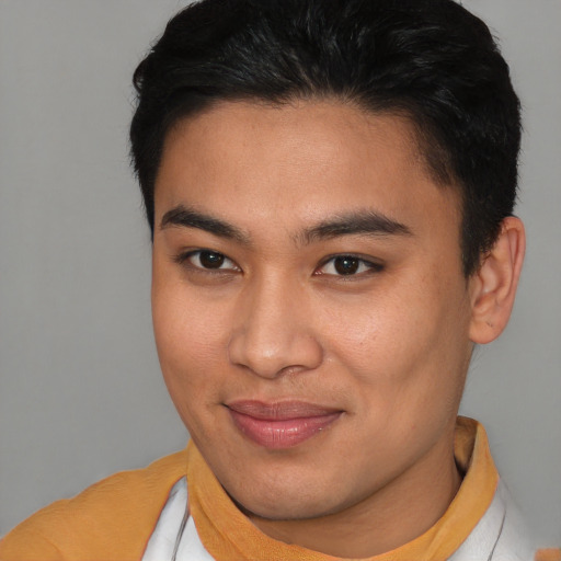 Joyful asian young-adult male with short  brown hair and brown eyes