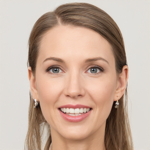 Joyful white young-adult female with long  brown hair and grey eyes