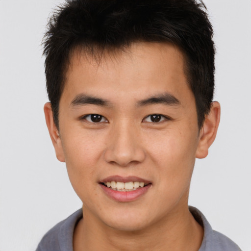 Joyful asian young-adult male with short  brown hair and brown eyes