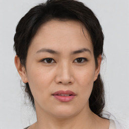 Joyful asian young-adult female with medium  brown hair and brown eyes