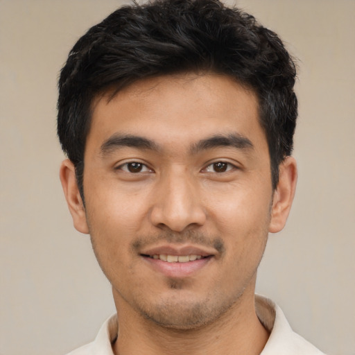 Joyful asian young-adult male with short  black hair and brown eyes