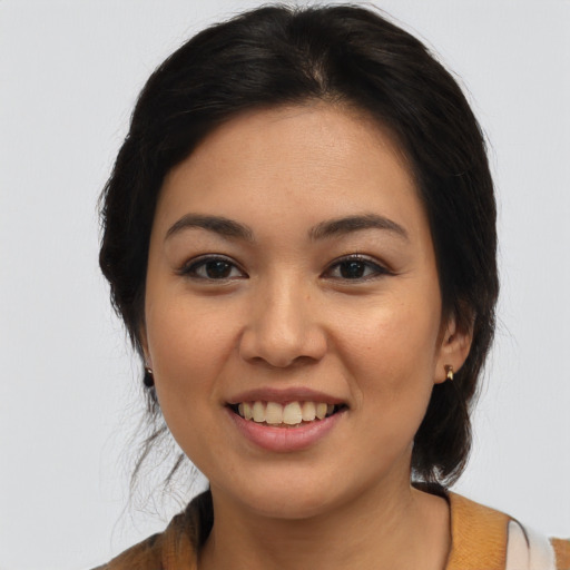 Joyful latino young-adult female with medium  brown hair and brown eyes