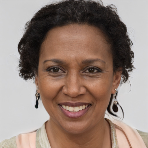 Joyful black adult female with short  brown hair and brown eyes