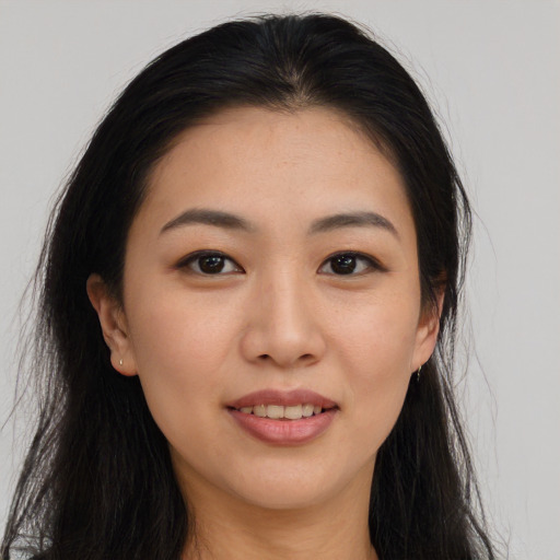 Joyful asian young-adult female with long  brown hair and brown eyes