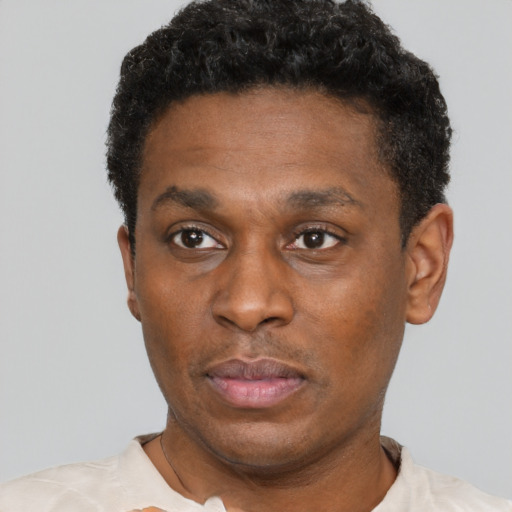 Neutral black adult male with short  black hair and brown eyes