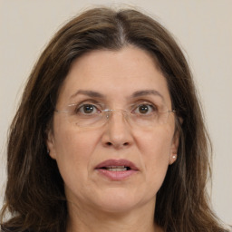 Joyful white adult female with long  brown hair and brown eyes