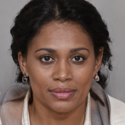 Joyful black adult female with short  brown hair and brown eyes