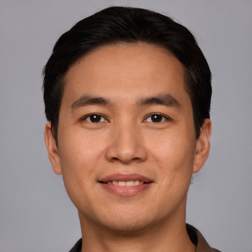 Joyful white young-adult male with short  black hair and brown eyes