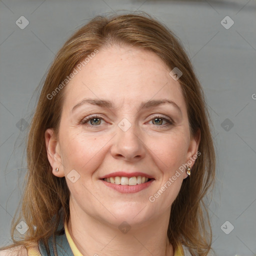 Joyful white adult female with medium  brown hair and blue eyes