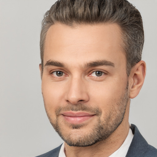 Joyful white young-adult male with short  brown hair and brown eyes