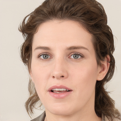 Joyful white young-adult female with medium  brown hair and green eyes