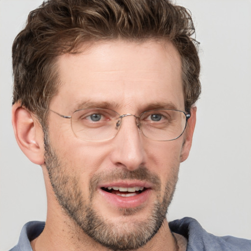 Joyful white adult male with short  brown hair and grey eyes