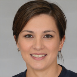 Joyful white young-adult female with medium  brown hair and brown eyes