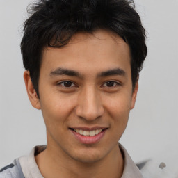 Joyful asian young-adult male with short  brown hair and brown eyes