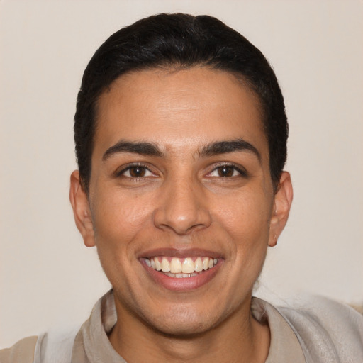 Joyful latino young-adult male with short  black hair and brown eyes