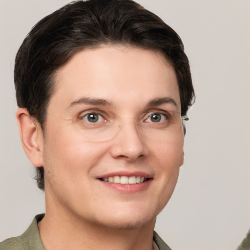 Joyful white young-adult female with short  brown hair and grey eyes