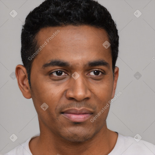 Joyful black young-adult male with short  black hair and brown eyes