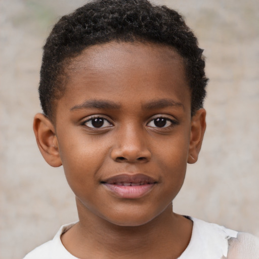 Joyful black child male with short  brown hair and brown eyes
