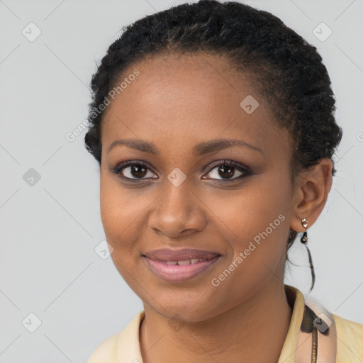 Joyful black young-adult female with short  brown hair and brown eyes