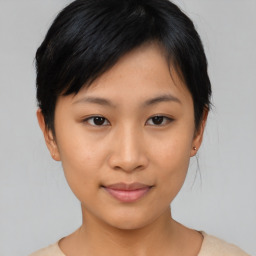 Joyful asian young-adult female with short  black hair and brown eyes