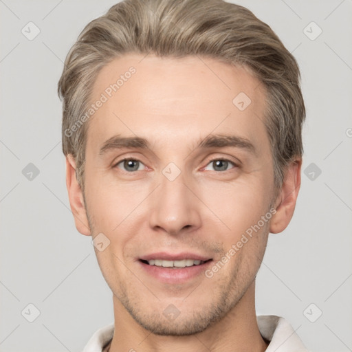 Joyful white adult male with short  brown hair and grey eyes