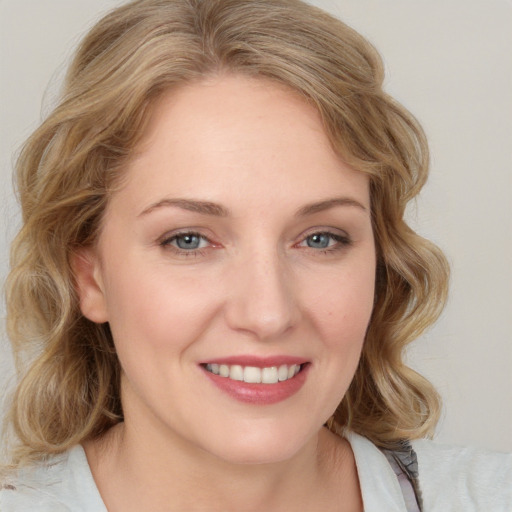 Joyful white young-adult female with medium  brown hair and blue eyes