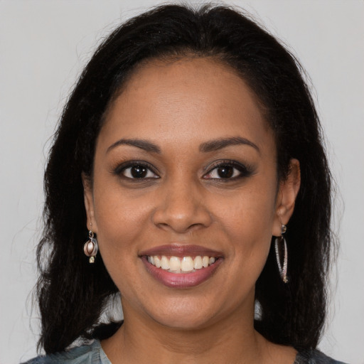 Joyful black young-adult female with medium  brown hair and brown eyes