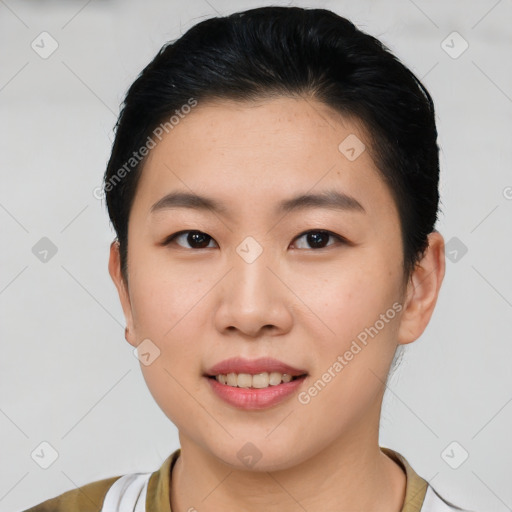 Joyful asian young-adult female with short  brown hair and brown eyes